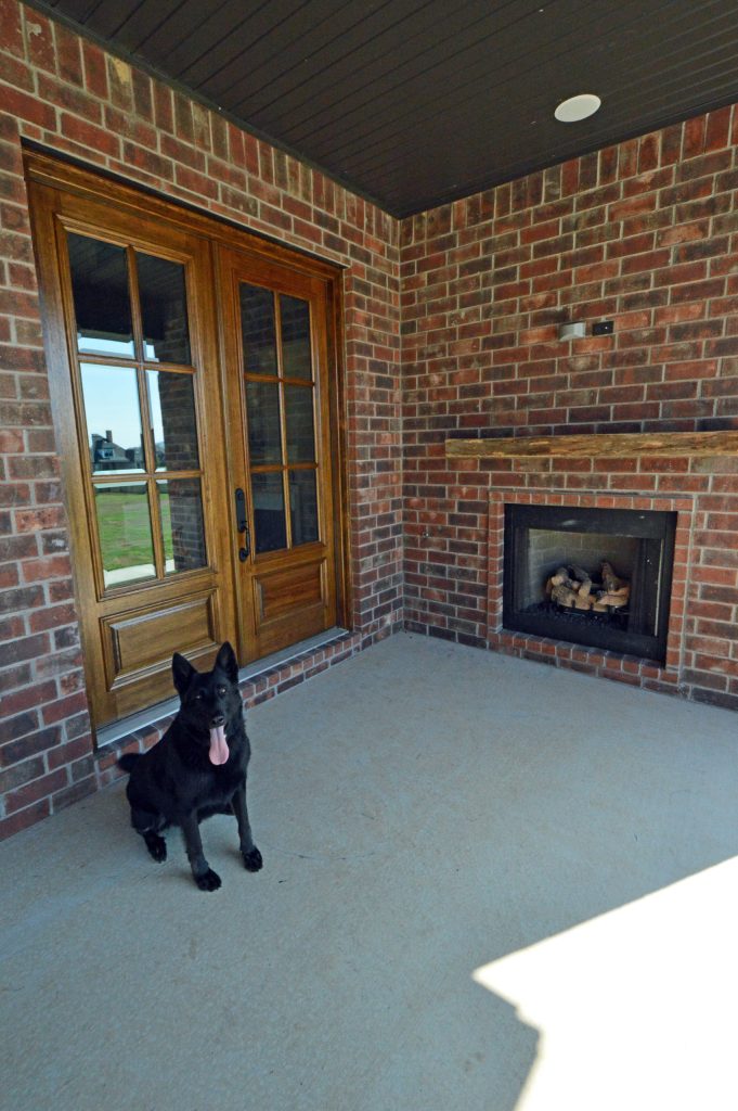 Custom home featuring open floor plan, formal dining room, study, wood tile floors, open banister overlooking kitchen and great room, custom cabinetry throughout, covered patio, two fireplaces, and more. by baumanncrosno | Outdoor Photos | Porch | Landscaping | Landscape Design | Outdoor Living Space | Porch Design Ideas | Outdoor Living Space Ideas | Backyard Design