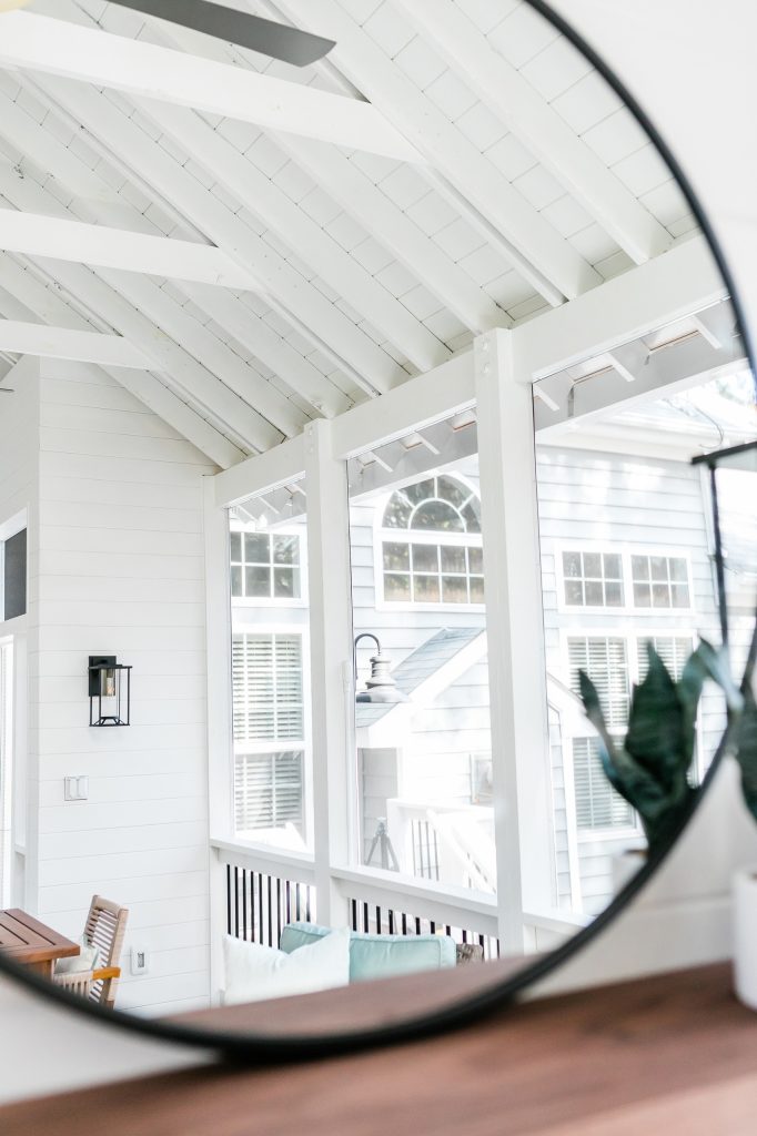 Custom outdoor Screen Porch with Scandinavian accents, mirror displaying amazing outdoor design details.
