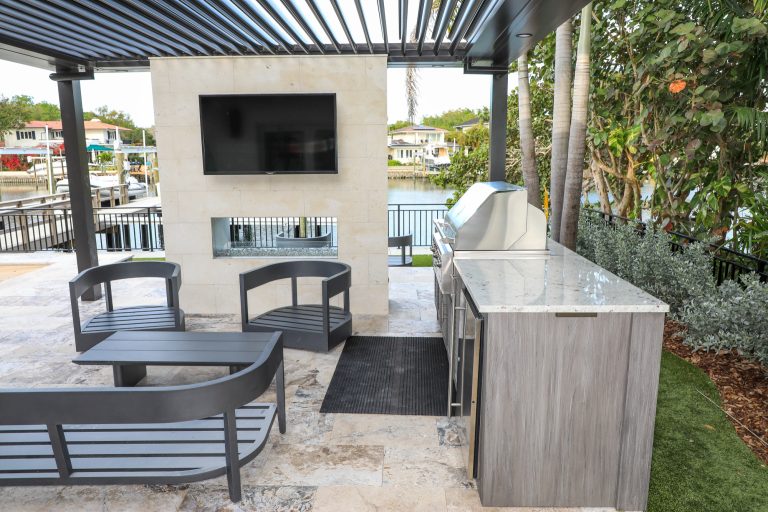 Custom outdoor kitchen build featuring 100% weatherproof outdoor cabinets, built-in gas grill and outdoor refrigerator.