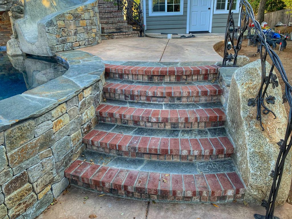 Custom railing built into the rock work