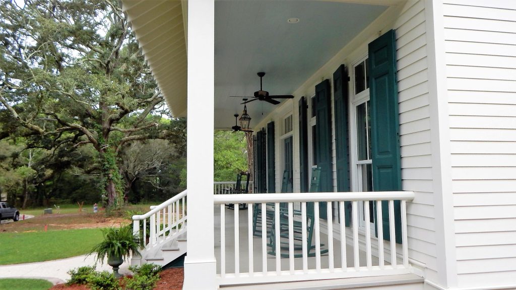 Custom railing surrounding front porch. Photo by Tom Aiken.