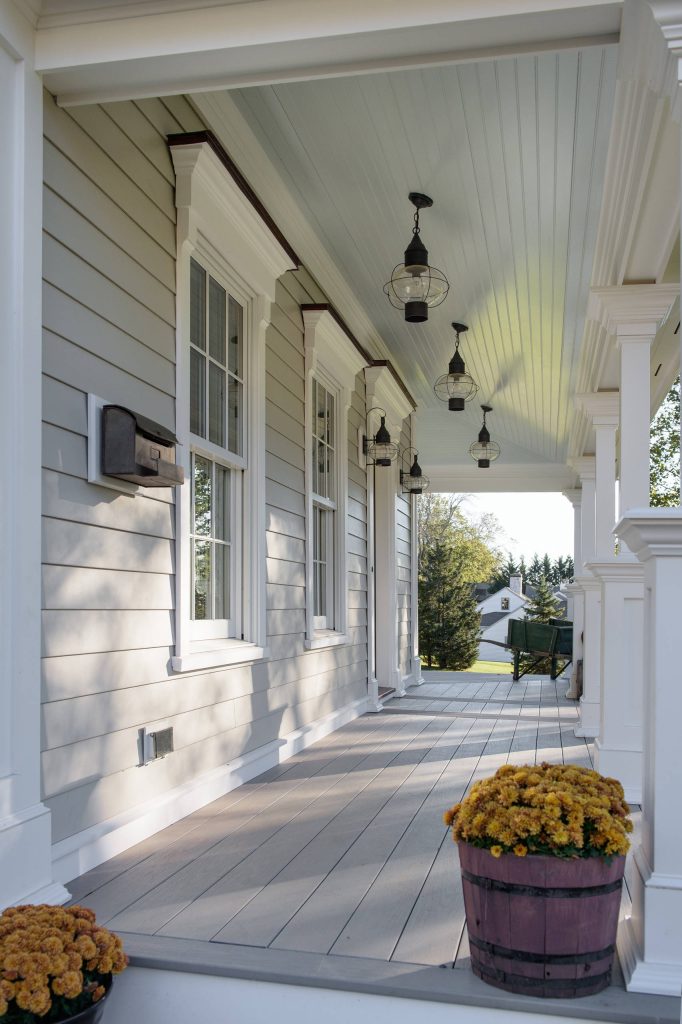 Custom wraparound porch with Wolf PVC composite decking, high gloss beaded ceiling, and hand crafted PVC architectural columns. Built for the harsh shoreline weather. by Advantage Contracting | Outdoor Photos | Porch | Landscaping | Landscape Design | Outdoor Living Space | Porch Design Ideas | Outdoor Living Space Ideas | Backyard Design
