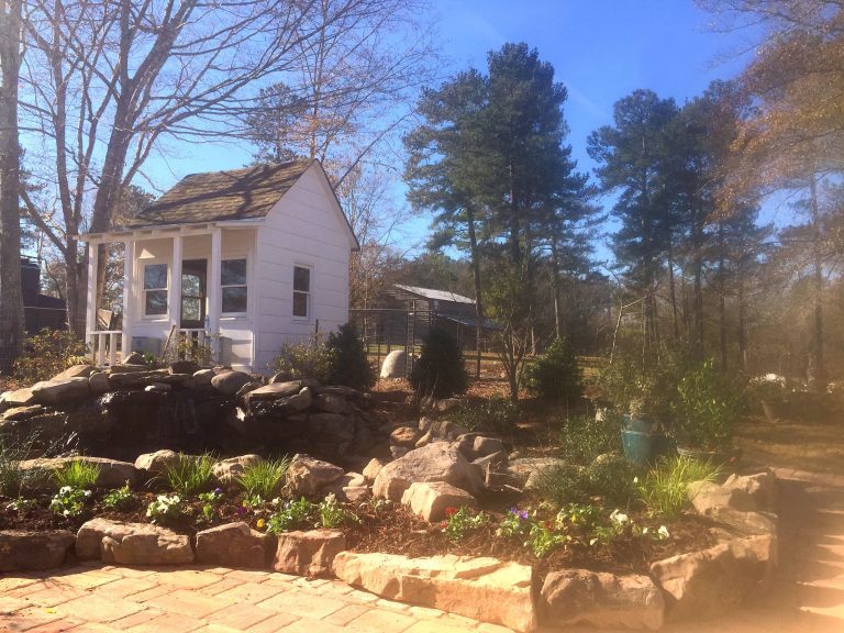 Daco Garden waterfall into a pond surrounded by natural stone and boulders