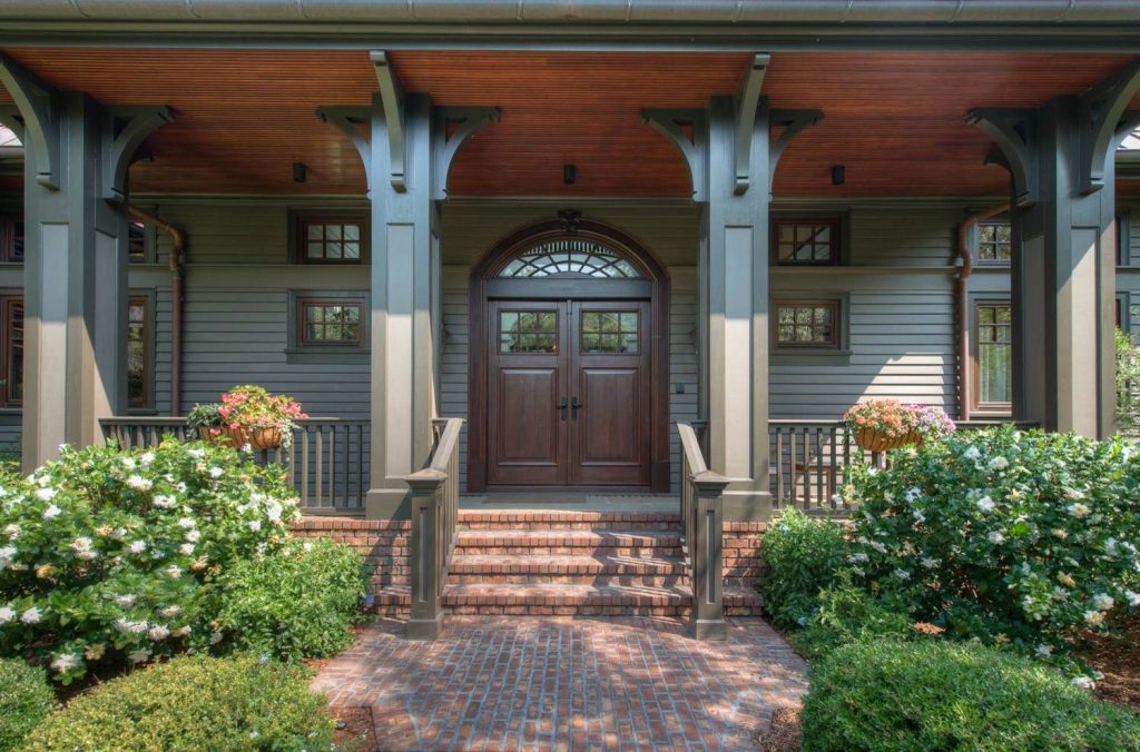 Dark Wood Double Door, Natural Fir Ceiling, and Painted Wood Columns with Brackets