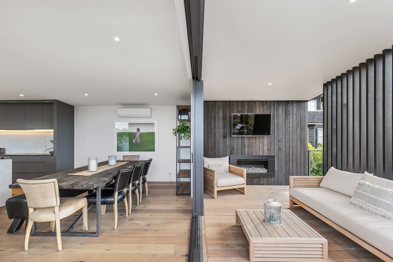 Deck - contemporary deck idea in Auckland with a fireplace and a roof extension