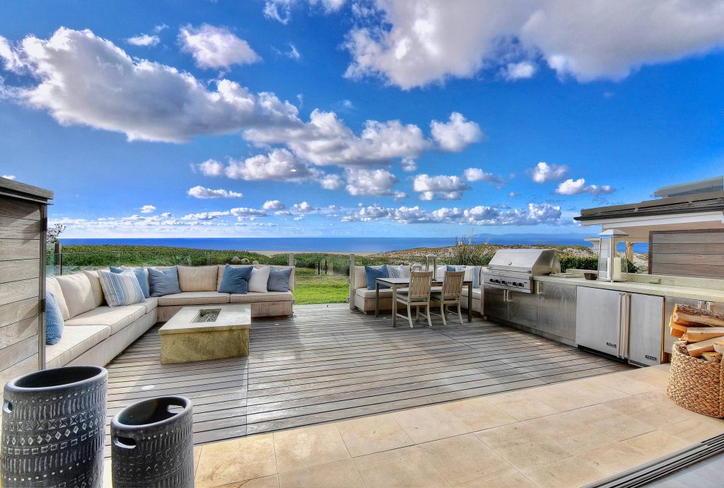 Deck - large coastal backyard deck idea in Orange County with no cover