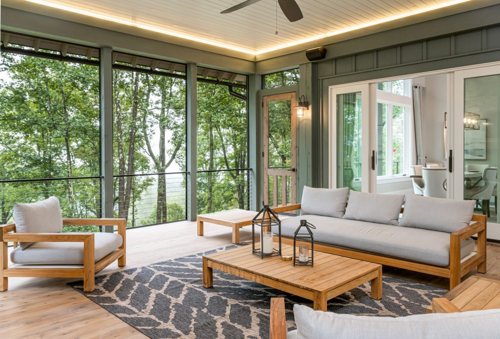 Deck - rustic cable railing deck idea in Other with a roof extension