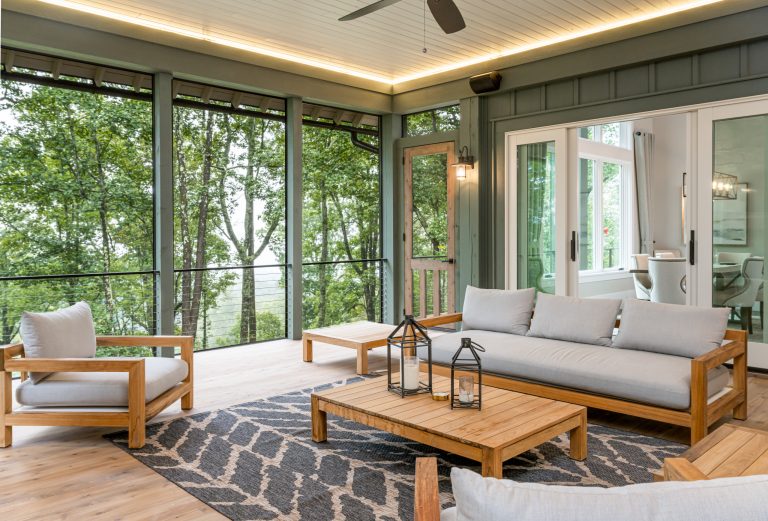 Deck - rustic cable railing deck idea in Other with a roof extension