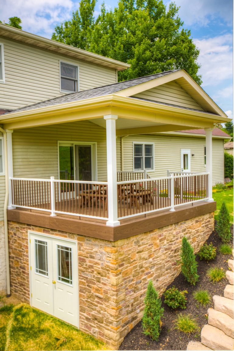 Deck with stone veneer storage area underneath. Roof over deck for shade.