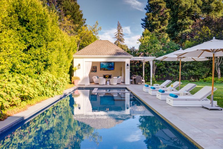 Define space by giving it gorgeous edges: a green wall, a cabana, a terrace with loungers. You'll never want to leave.
