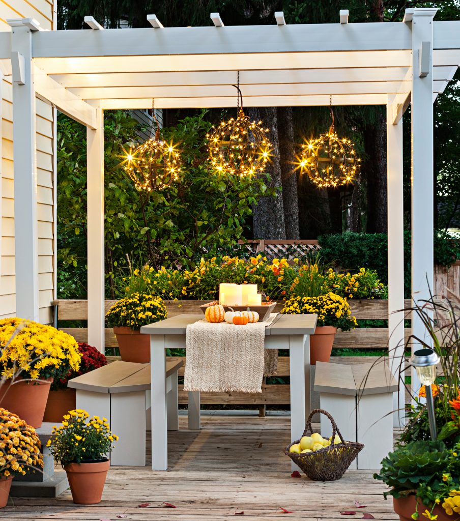 Delight in your deck throughout the fall by creating a cozy gathering spot.