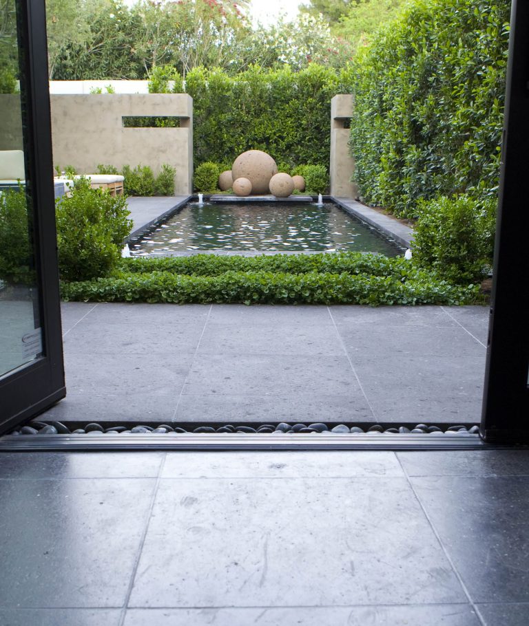 Design ideas for a contemporary backyard stone landscaping in Phoenix.