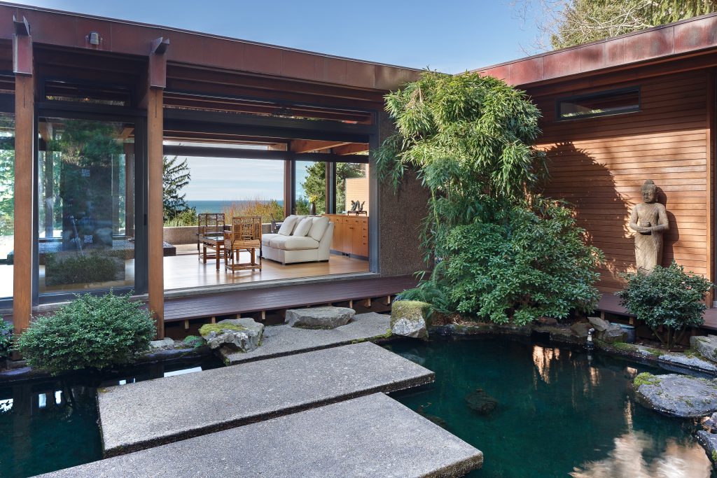 Design ideas for a large asian partial sun backyard concrete paver landscaping in Other for spring.