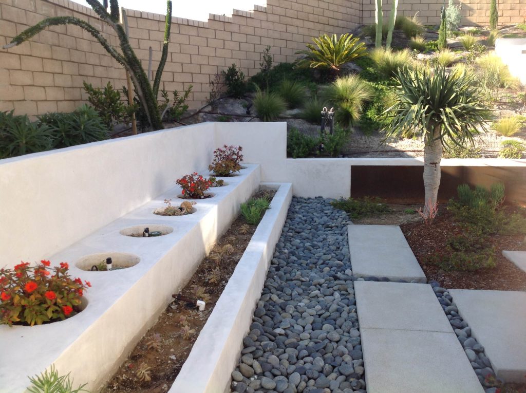Design ideas for a large modern drought-tolerant and partial sun backyard concrete paver landscaping in San Diego for summer.