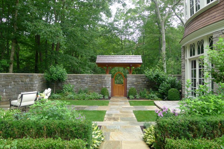 Design ideas for a large traditional backyard stone landscaping in New York with a pergola.