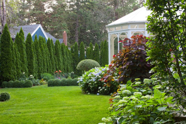 Design ideas for a large traditional partial sun backyard formal garden in New York.