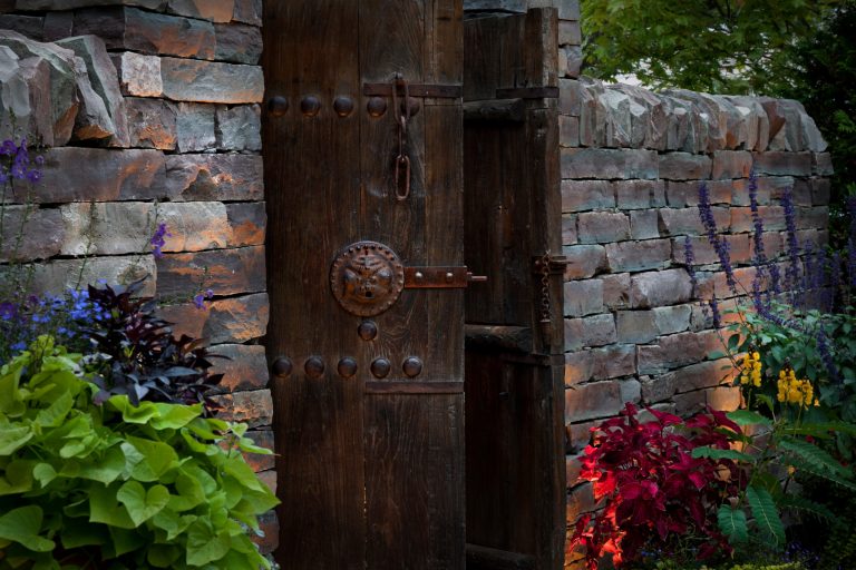 Design ideas for a mid-sized rustic backyard stone garden path in Detroit.