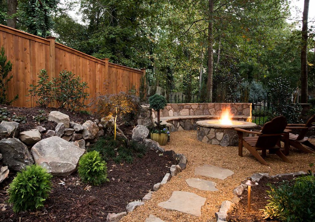 Design ideas for a rustic full sun backyard gravel landscaping in Atlanta with a fire pit.
