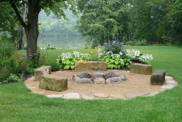 Design ideas for a traditional shade backyard gravel landscaping in Columbus with a fire pit for summer.