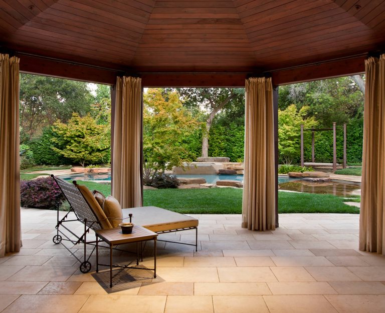 Designed and built by Pacific Peninsula Group. Exterior veranda frames views of the backyard and pool. Photography by Bernard Andre