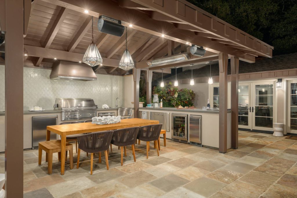 Designed to compliment the existing single story home in a densely wooded setting, this Pool Cabana serves as outdoor kitchen, dining, bar, bathroom/changing room, and storage. Photos by Ross Pushinaitus.