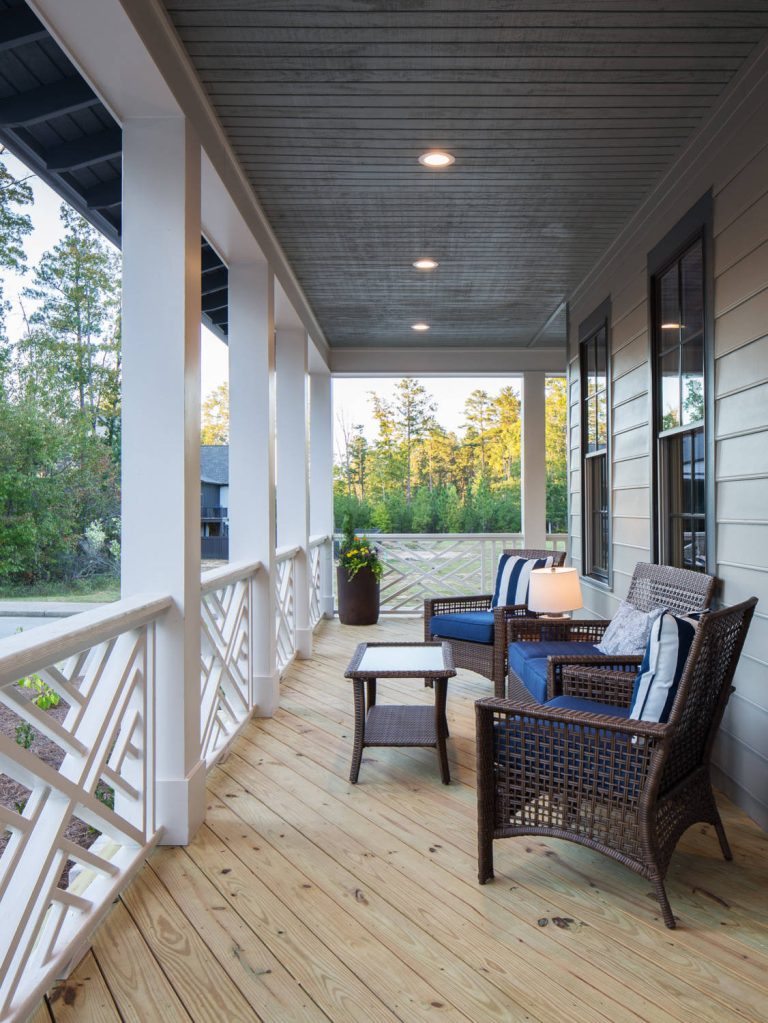 Detailed shot of the custom railing on the wraparound porch for the Southern Living Inspired Home in Mt Laurel. Built by Mt Laurel's Town Builders Photo by Tommy Daspit by Town of Mt Laurel | Outdoor Photos | Porch | Landscaping | Landscape Design | Outdoor Living Space | Porch Design Ideas | Outdoor Living Space Ideas | Backyard Design