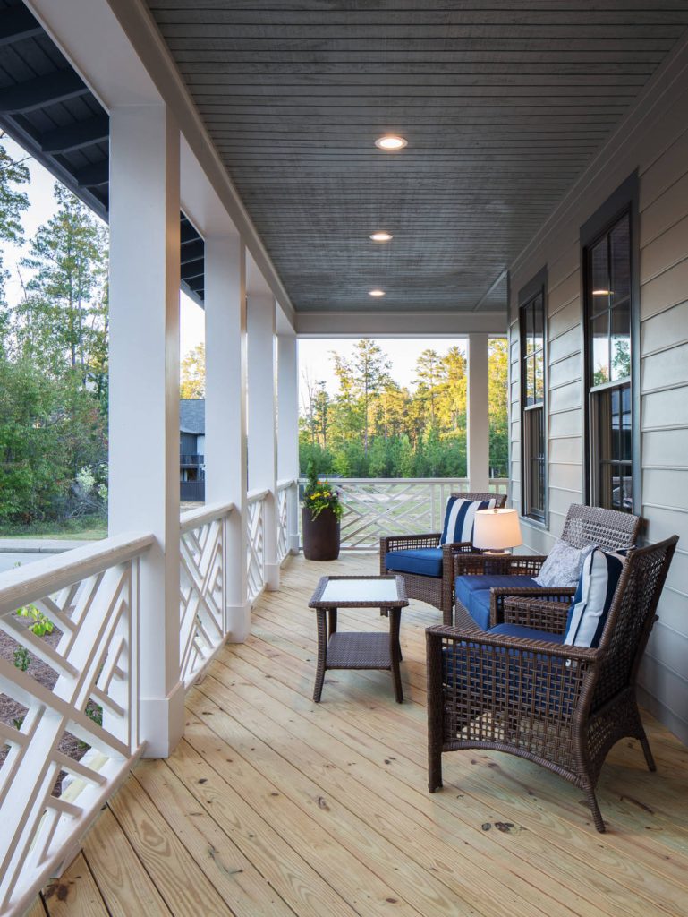 Detailed shot of the custom railing on the wraparound porch for the Southern Living Inspired Home in Mt Laurel. Built by Mt Laurel's Town Builders Photo by Tommy Daspit by Town of Mt Laurel | Outdoor Photos | Porch | Landscaping | Landscape Design | Outdoor Living Space | Porch Design Ideas | Outdoor Living Space Ideas | Backyard Design