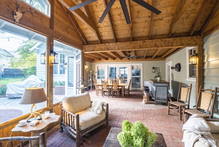 Dining and living space on a screen porch.
