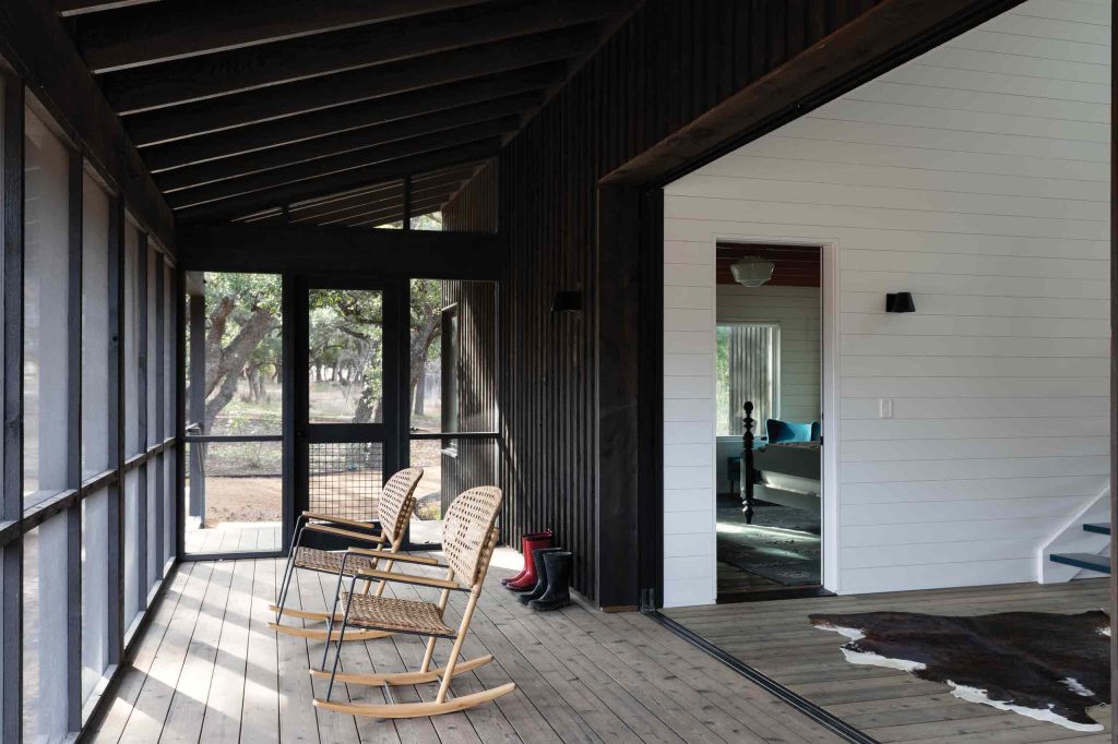 Disappearing glass wall separates breezeway/dining room from screened porch. Photo by Whit Preston