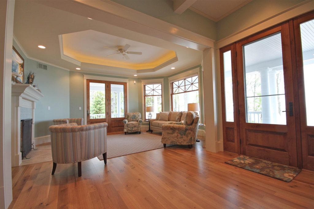 Doors at each end of the main central hall and the side of living room allow for easy access to wrap around porches. Photo courtesy of Cottage Home, Inc. by AB2 Architecture | Outdoor Photos | Porch | Landscaping | Landscape Design | Outdoor Living Space | Porch Design Ideas | Outdoor Living Space Ideas | Backyard Design