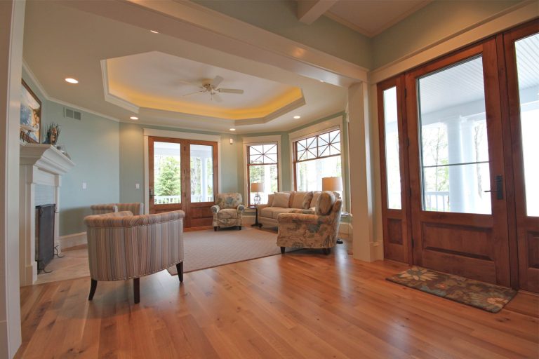 Doors at each end of the main central hall and the side of living room allow for easy access to wrap around porches. Photo courtesy of Cottage Home, Inc. by AB2 Architecture | Outdoor Photos | Porch | Landscaping | Landscape Design | Outdoor Living Space | Porch Design Ideas | Outdoor Living Space Ideas | Backyard Design