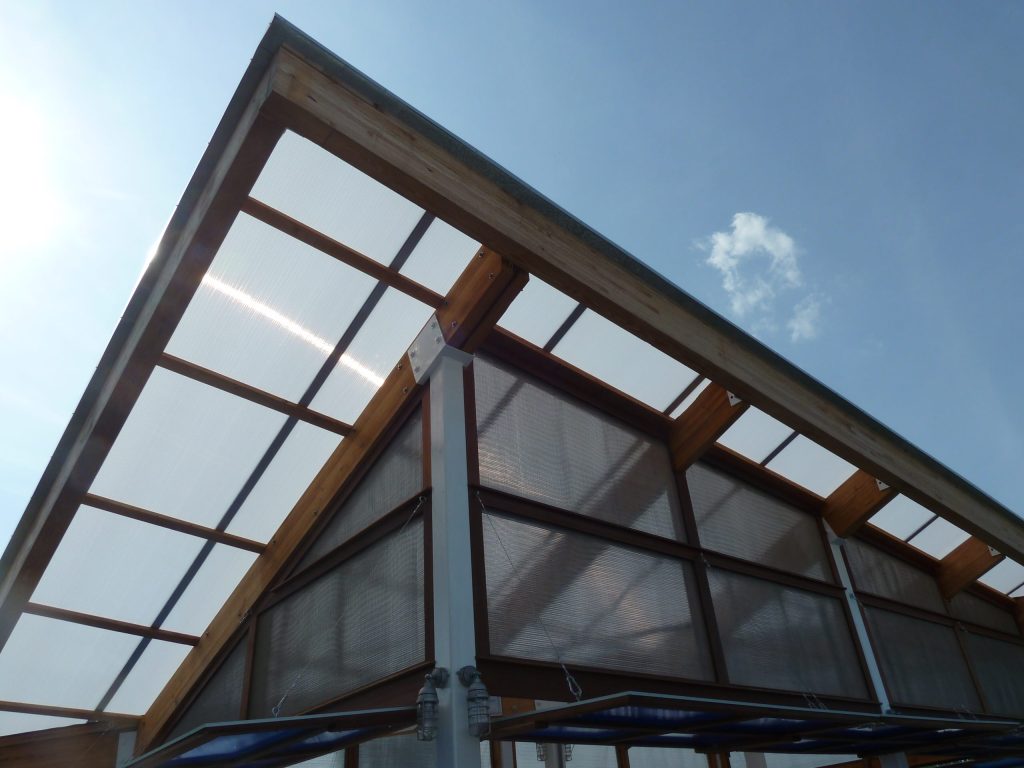 Dramatic. bold lines against an azure blue sky protect customers from the sun and a light shower while sitting outside.