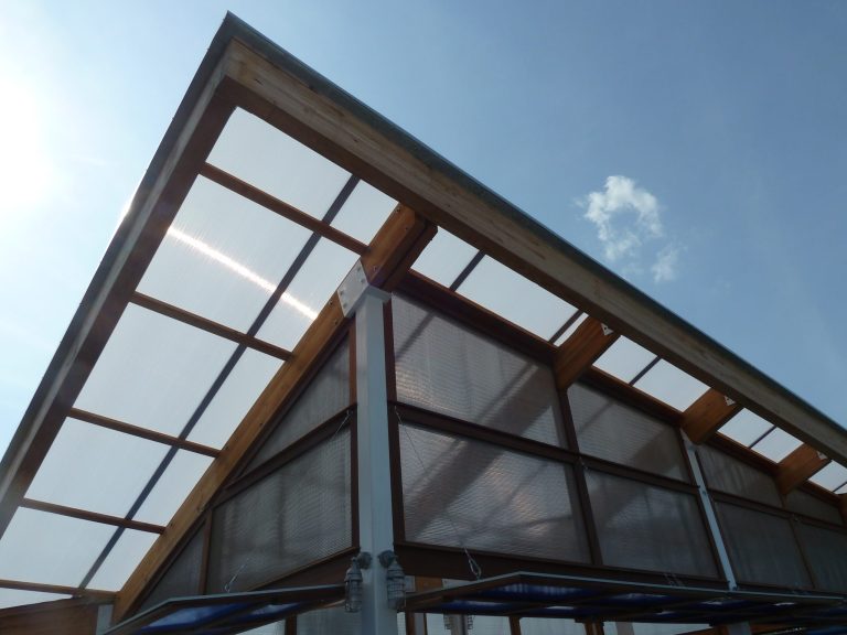 Dramatic. bold lines against an azure blue sky protect customers from the sun and a light shower while sitting outside.