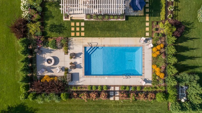 Drone photography of Cedarburg pool project clearly shows how the fire pit area is located on the centerline of the pool. Edmunds Studios Photography
