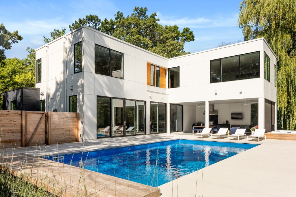 Easy access through patio doors to indoor outdoor living and entertaining. Modern patio furniture and well equipped outdoor kitchen and dining surround the modern pool.