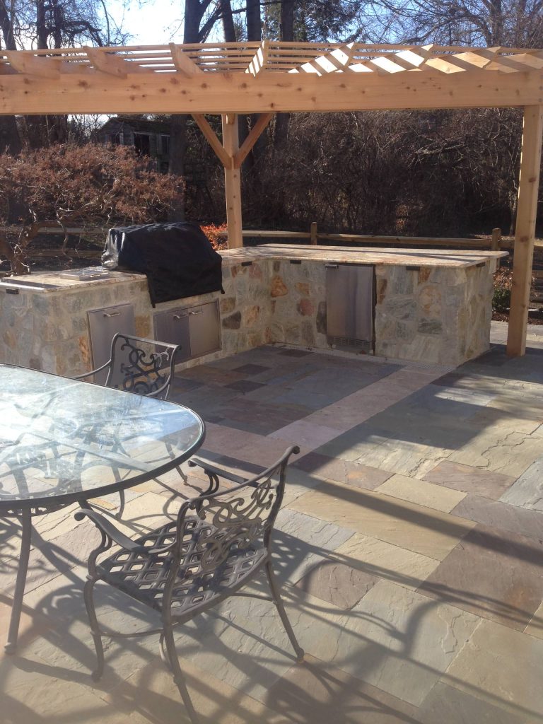 Elegant backyard patio kitchen photo in Philadelphia with a pergola