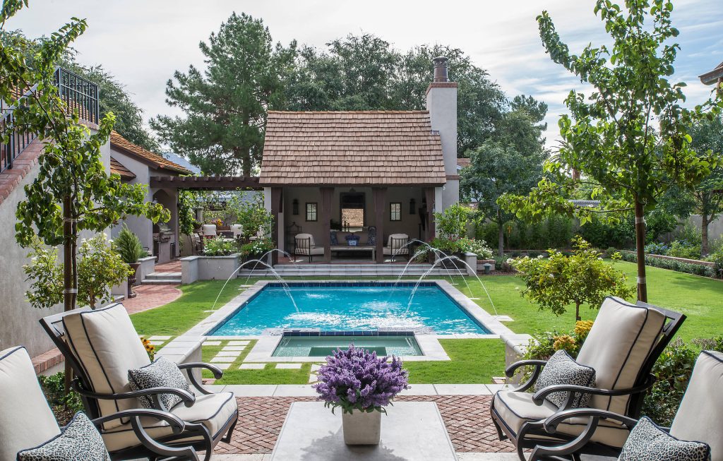 Elegant backyard rectangular pool house photo in Phoenix
