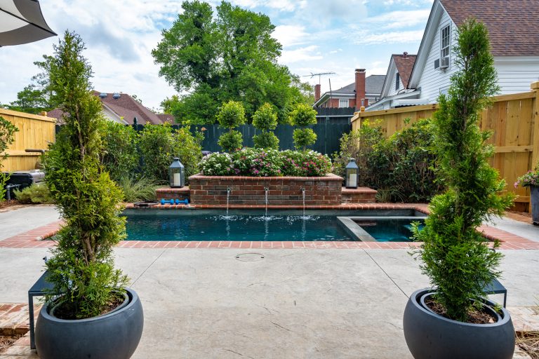 Elegant brick and rectangular hot tub photo in Atlanta