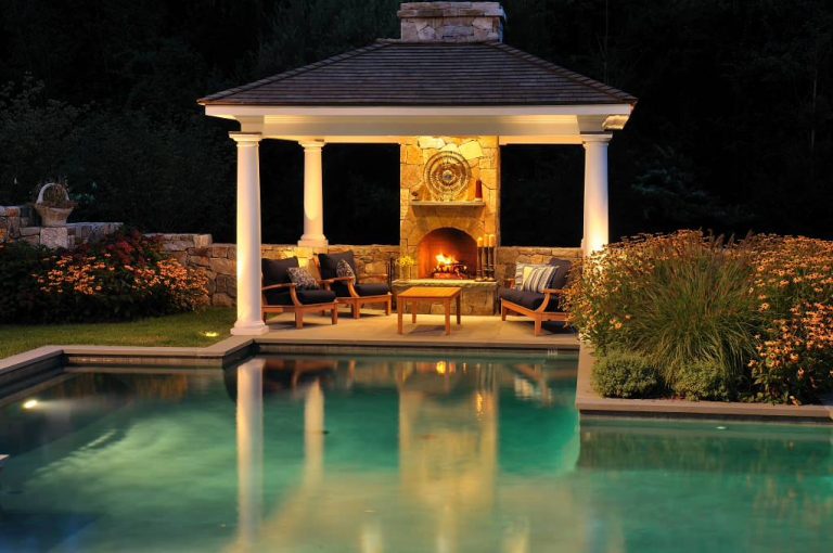 Elegant custom-shaped pool house photo in New York