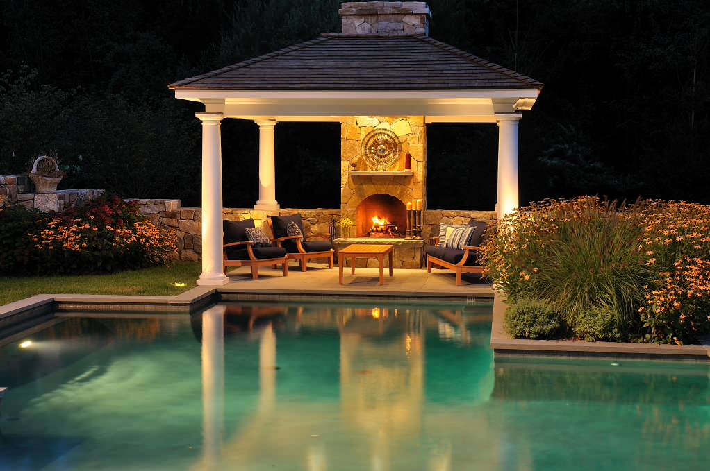 Elegant custom-shaped pool house photo in New York