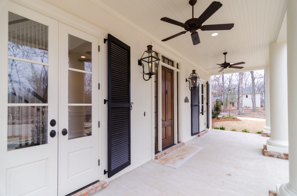 Elegant front porch photo in New Orleans by Provenance Realty Group | Outdoor Photos | Porch | Landscaping | Landscape Design | Outdoor Living Space | Porch Design Ideas | Outdoor Living Space Ideas | Backyard Design