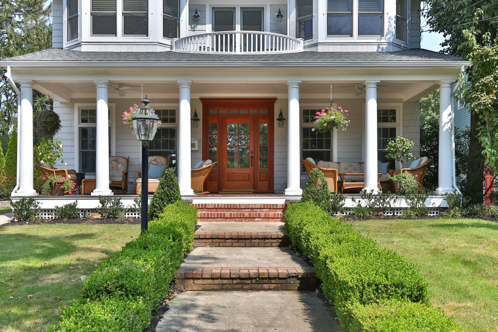 Elegant front porch photo in New York with a roof extension by Universal Builders, Inc | Outdoor Photos | Porch | Landscaping | Landscape Design | Outdoor Living Space | Porch Design Ideas | Outdoor Living Space Ideas | Backyard Design