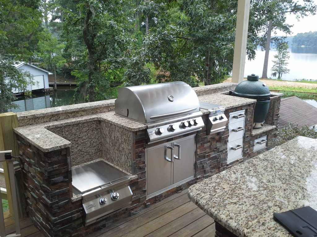 Elegant outdoor kitchen deck photo in Other with a pergola