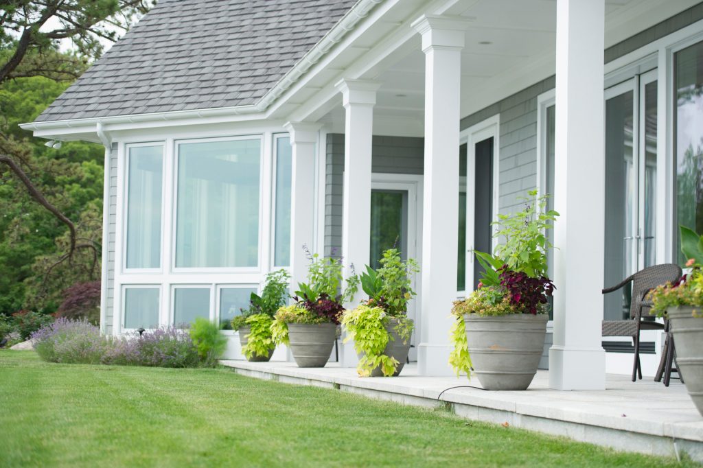 Elegant stone porch photo in Bridgeport with a roof extension by Christensen Landscape Services | Outdoor Photos | Porch | Landscaping | Landscape Design | Outdoor Living Space | Porch Design Ideas | Outdoor Living Space Ideas | Backyard Design