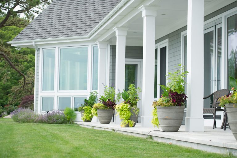 Elegant stone porch photo in Bridgeport with a roof extension by Christensen Landscape Services | Outdoor Photos | Porch | Landscaping | Landscape Design | Outdoor Living Space | Porch Design Ideas | Outdoor Living Space Ideas | Backyard Design