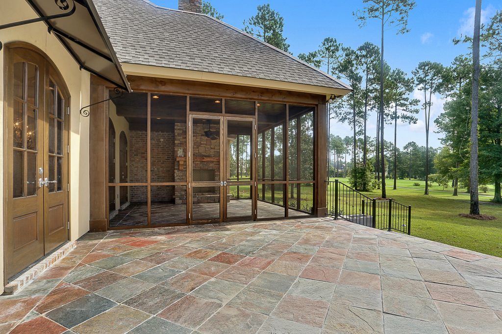 Elegant tile screened-in back porch photo in New Orleans with a roof extension by Ron Lee Homes | Outdoor Photos | Porch | Landscaping | Landscape Design | Outdoor Living Space | Porch Design Ideas | Outdoor Living Space Ideas | Backyard Design