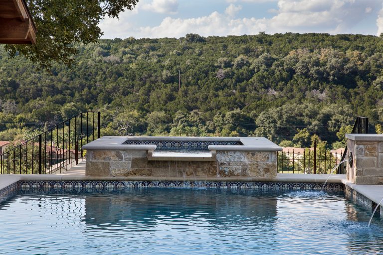 Elevated spa cascading into pool provides the acoustics of a water feature and the stunning views from the highpoint on the property overlooking the lake below.

Photo by Rachel Paul Malkowski by Double B Design, LLC | Pool design | Pool Contracting | Swimming Pool Ideas | Swimming Pool Design Ideas