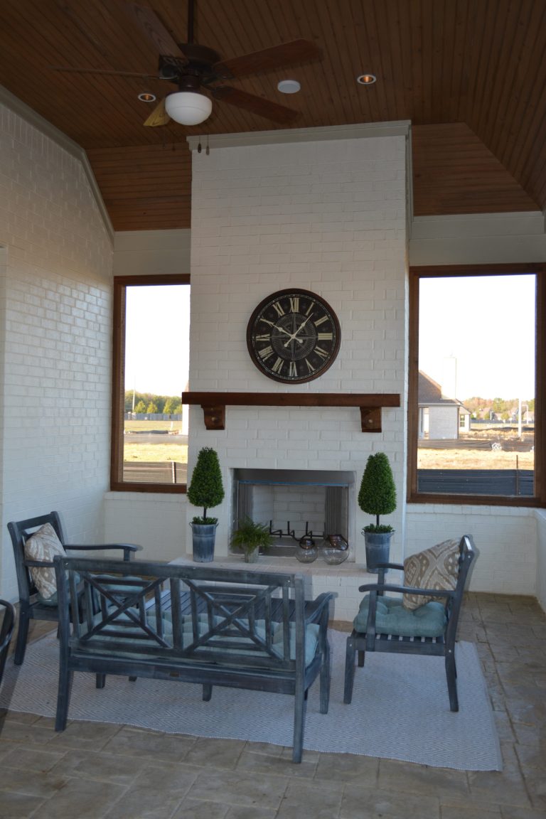 Enclosed porch area with fireplace.