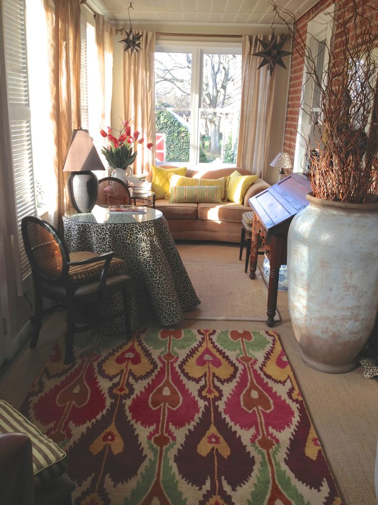 Enclosed porch of original farmhouse now functions as a morning room for reading and relaxation.