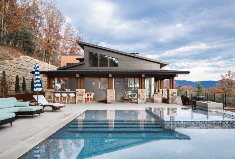 Example of a 1960s backyard concrete and rectangular infinity pool design in Other